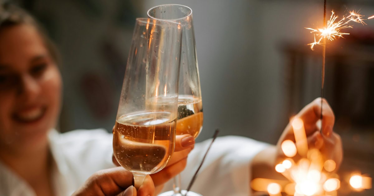 Celebration with champagne glasses and sparklers at an event, festive atmosphere.
