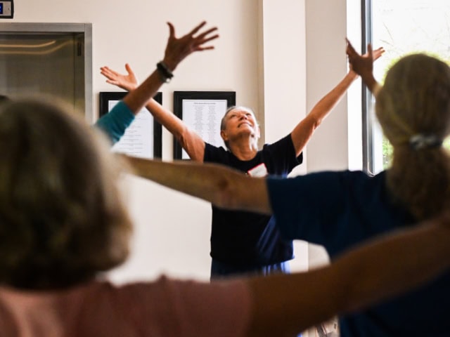 Man with cap hits ball with raquet