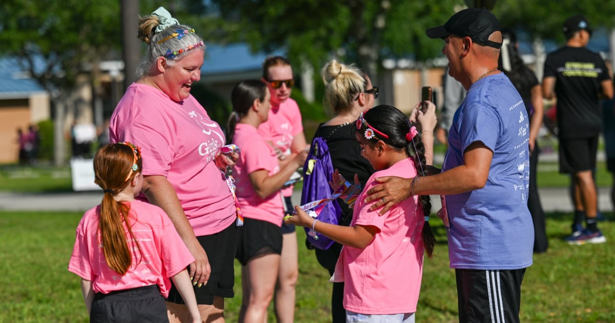 Girls on the Run students and coaches at the end of the race smiling